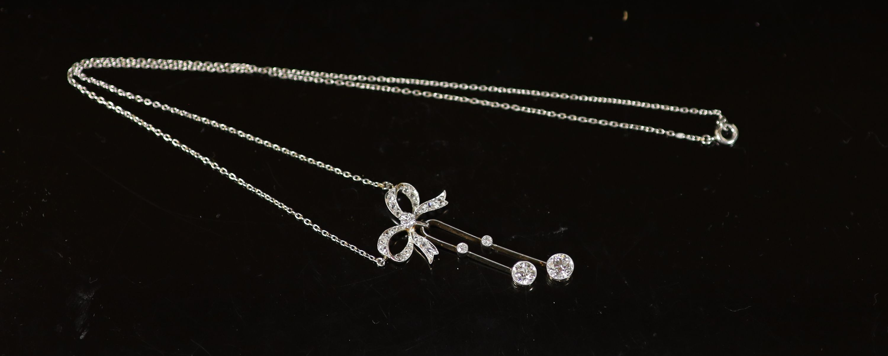 An early 20th century white and yellow gold, graduated diamond set double drop line pendant necklace